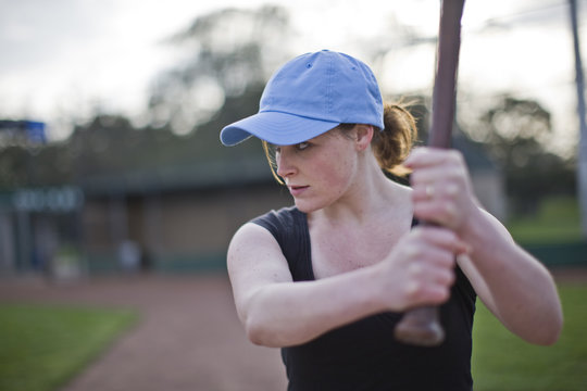 Woman preparing to bat while playing baseball