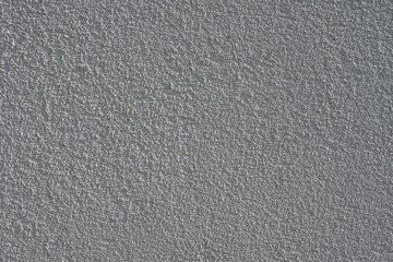 Obraz premium The background of light walls with raised plaster.
