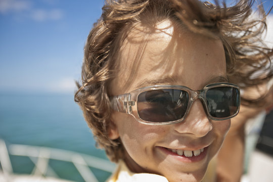 Portrait of a smiling young boy on a boat.