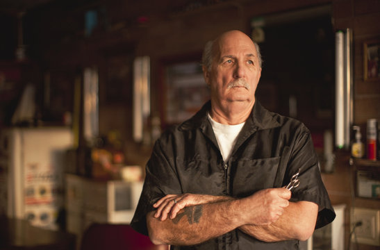 Portrait of serious mature man with arms folded.
