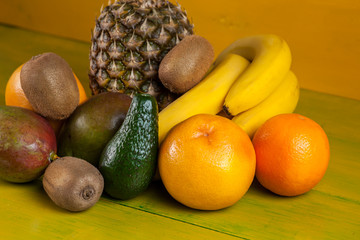 Tropical fruit on yellow wooden background, fresh food