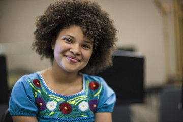 Portrait of teenage girl smiling at school.