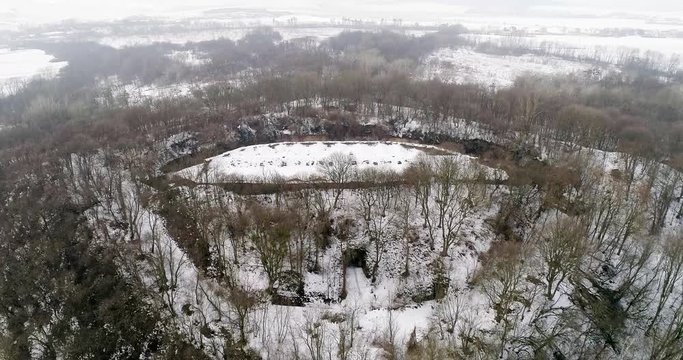 Aerial view of beautiful ancient fortress in forest in winter. Tarakaniv Fort.