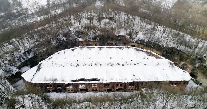 Aerial view of beautiful ancient fortress in forest in winter. Tarakaniv Fort.