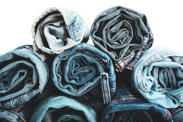 Close up rolled of blue jeans pants, dark blue denim trousers showing texture on white