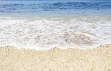 Fototapeta na wymiar Soft wave of blue sea on sandy Beach. Ocean beach background