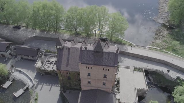Aerial view of Historical and cultural complex Castle-museum Radomysl- the museum of Ukrainian home icons. Flying around the Radomyshlsky Castle with a view of the surrounding landscapes of the lake