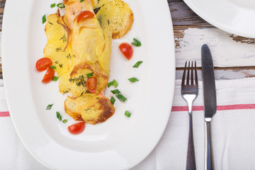 Fish in baked potatoes decorated with cherry tomatoes