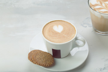 Coffee cup of cafe latte with heart latte art on top