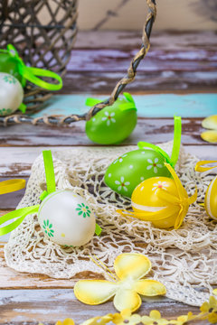 Easter eggs on wooden background colorful green yellow basket