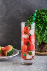Watermelon lemonade on with colorful drinking straw fresh basil