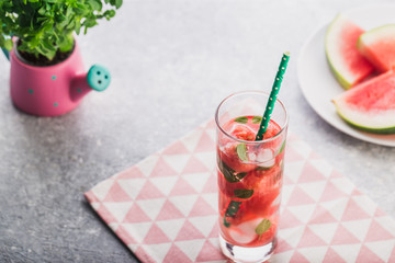 Watermelon lemonade on with colorful drinking straw fresh basil