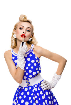 woman in pin-up style, applying lipstick