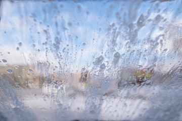 car wash. view from inside. windshield in drops view from inside