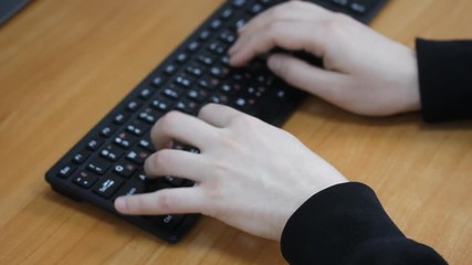 Male hands close-up print text on the keyboard
