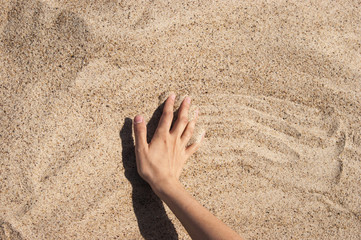 Background with hand on the sand