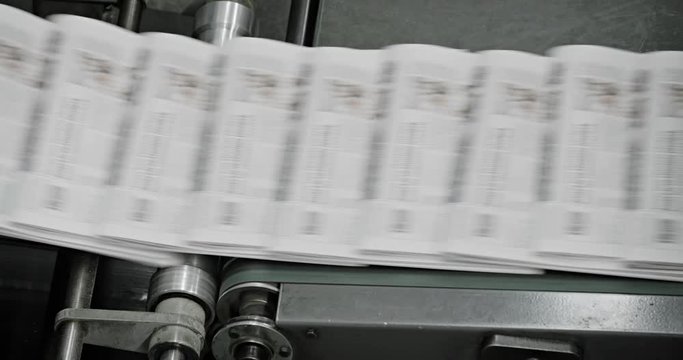 Tomorrow's newspapers are moved through the factory on conveyor belts.