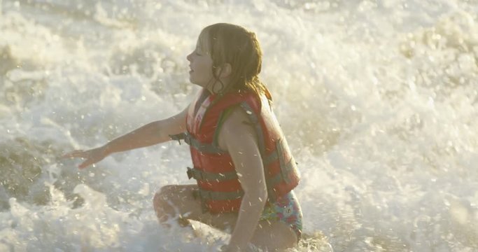Girl playing in the waves