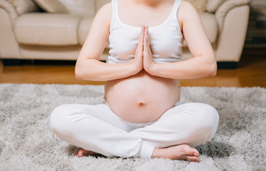 Fototapeta na wymiar Pregnant woman. Yoga at home. Relaxation.