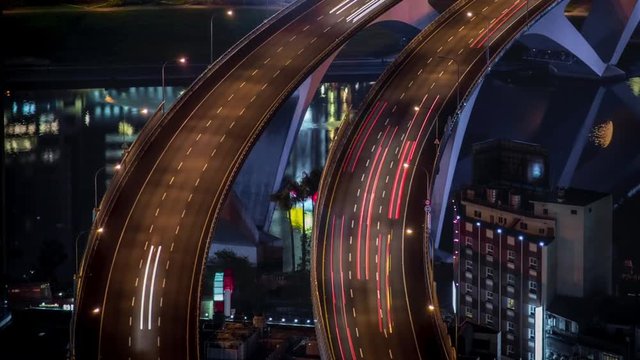 Travelling aerial view of highway bridge with busy traffic in nigth Taipei city. Beautiful Timelapsed freeway in cityscape. Cars ligth exposure. Mountain Xindian-Dan