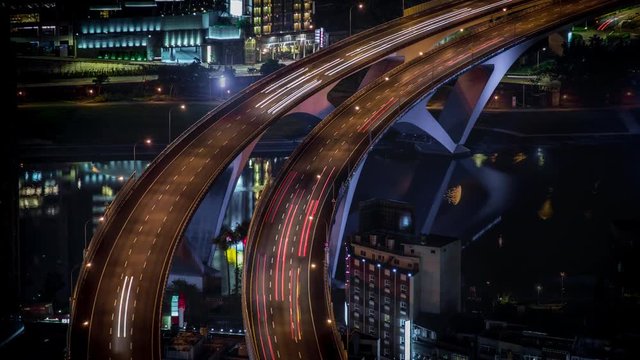 4K Timelapse aerial view of highway bridge with busy traffic in nigth Taipei city. Beautiful Timelapsed freeway in cityscape. Cars ligth exposure. Mountain Xindian-Dan