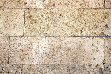 Relief sandy surface of decorative stone wall. Texture background