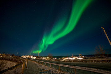 Fototapeta na wymiar Northern lights over the vilage of Reine, Lofoten, Norway