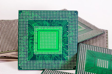 Computer electronic chips isolated on white arranged in a stack. The chips are placed upside down...
