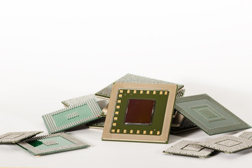 Computer electronic chips isolated on white arranged in a stack. The chips are placed upside down...