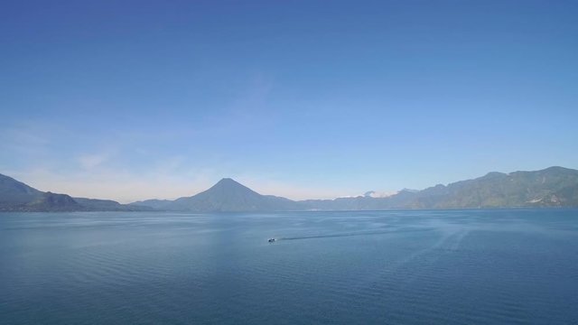 Aerial over Lake Amatitlan in Guatemala reveals the Pacaya Volcano.