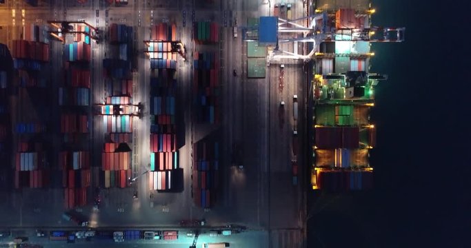 Video Container ship in export and import business and logistics. Shipping cargo to harbor by crane. Water transport International. Aerial view