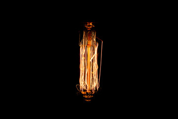 Low light of vintage light bulb filament isolated on black background