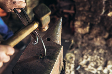 Blacksmith forging a horseshoe