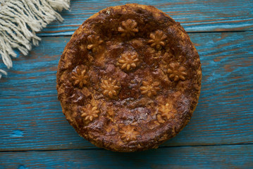 Round Loaf Karavai on wooden rustic table background. Traditional slavic russian and ukranian festivals and weddings bread, close-up