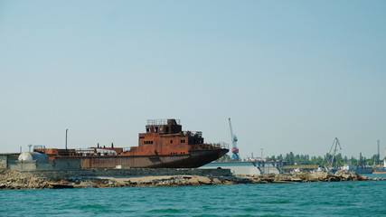 old rusty ship stands in the port on the seashore