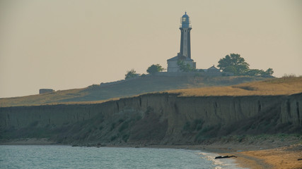 sea lighthouse coast of Crimea on the rocky shores in the Black Sea in the evening
