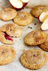 Crispy mini pies with apple and red currant. Rustic style.