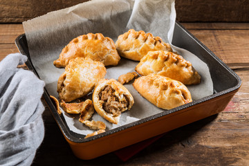 Hot pasties from butter enriched puff pastry filled with minced beef, potato, onions and swede