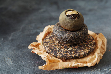Asian pressed pu-erh tea and shu pu'er in tangerine