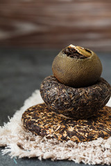 Asian pressed pu-erh tea and shu pu'er in tangerine