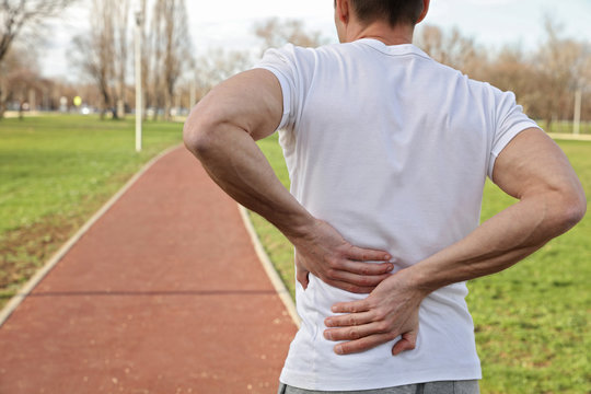 Sport injury, Man with back pain. Pain relief and health care concept.