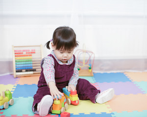 baby girl play toy blocks at home