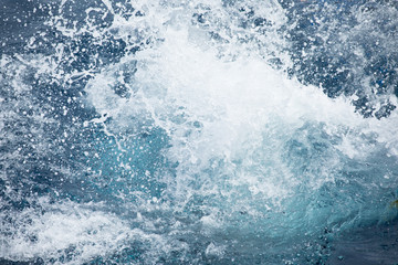 Fototapeta na wymiar Big blue water splash after people jump in sea