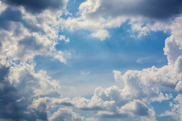 White curly clouds in a blue sky. Sky background