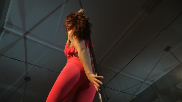 Sexy blackhair girl pole dance in pink