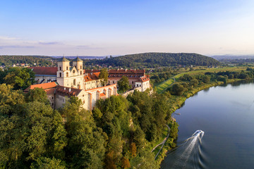 Fototapeta na wymiar Benedictine abbey on the rocky hill in Tyniec near Cracow, Poland, and Vistula River. Aerial view at sunset