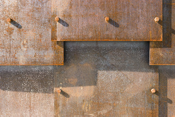 Rusty metal plates with bolts 