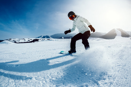 one snowboarder snowboarding in winter mountains
