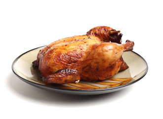 Whole roasted chicken against white background