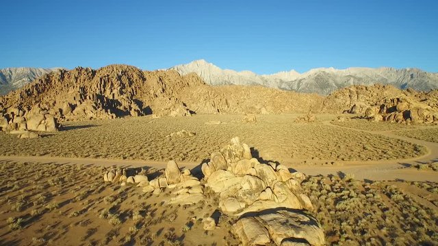 An aerial shot over the Alabama Hills outside Lone Pine California with Mt. Whitney and Sierras background.